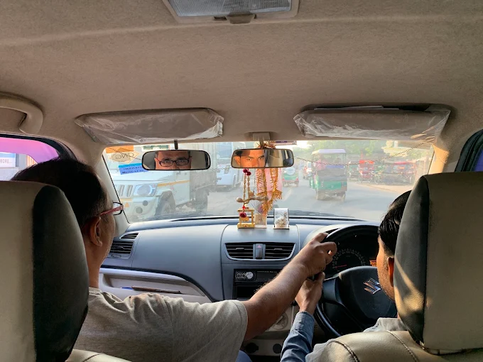 Instructor guiding a learner during an on-road driving lesson